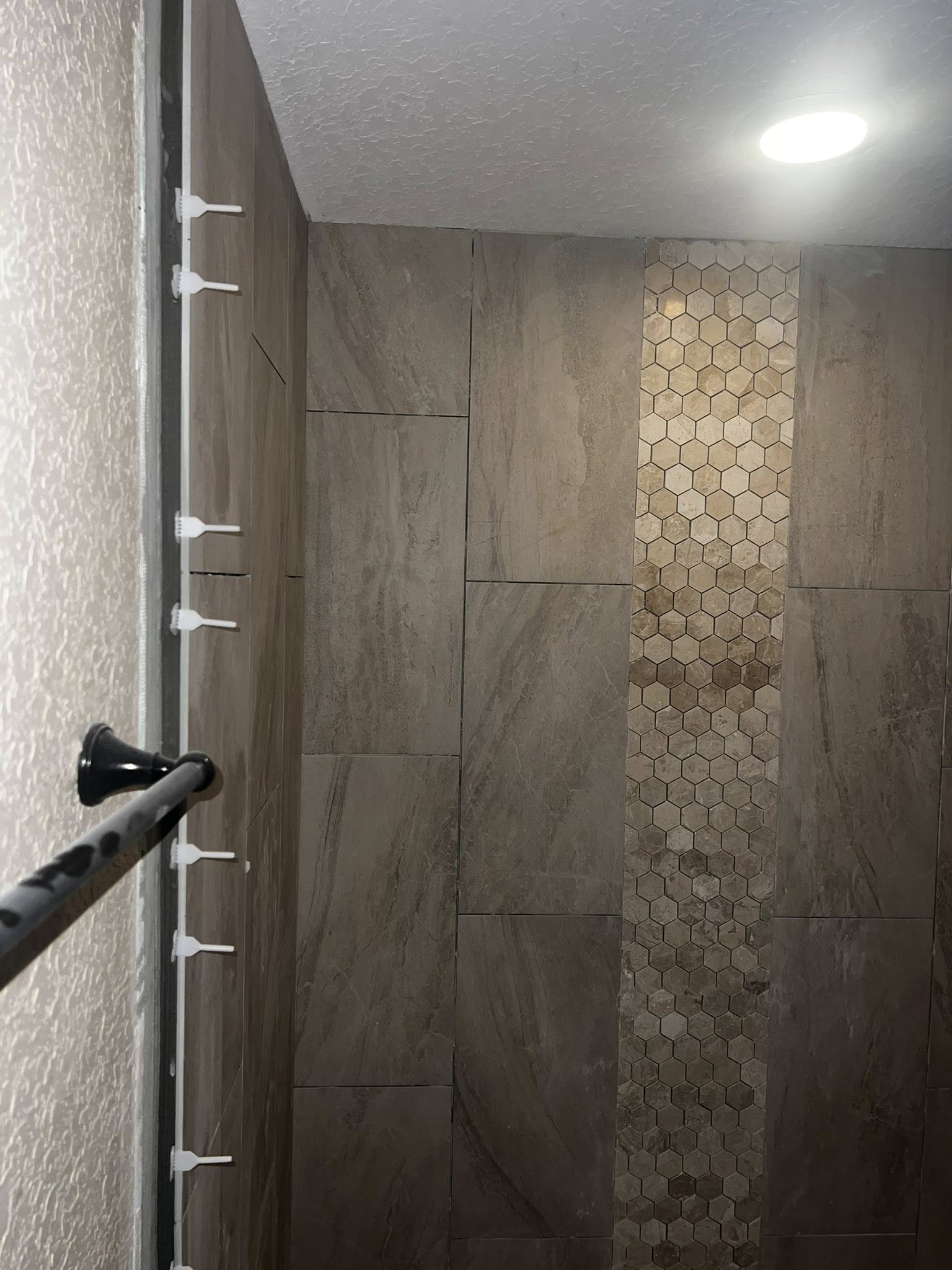 Why the First Row of Tile Matters So Much 2 not plumb wall